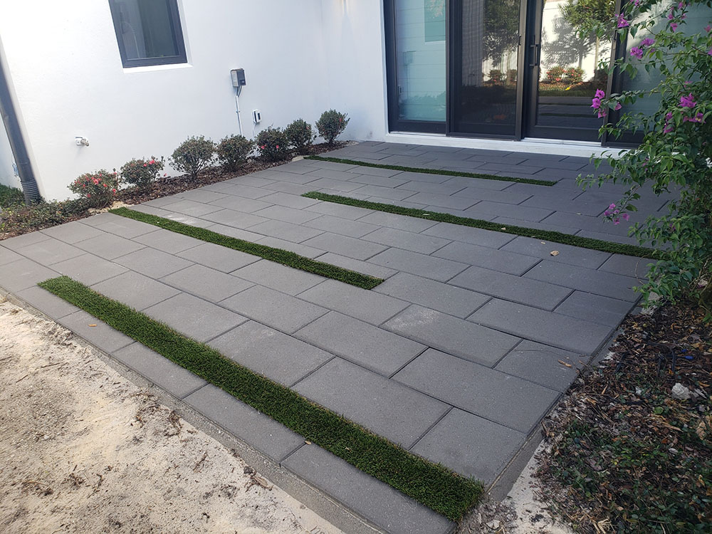 Booths Cobblestones | Central Florida's #1 Hardscape Contractor | Patio Charcoal Concrete Paver with Artificial Turf Strips 2