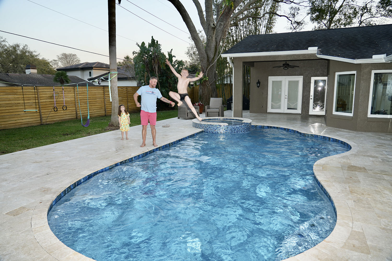 Booths Cobblestones | Central Florida's #1 Hardscape Contractor | Pool Deck Family Kid Jumping 1